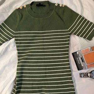 Olive green shirt and brand Sweet Wanderer. It’s in a size Medium in Women’s.